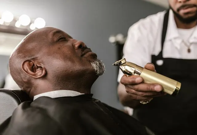 Barber trimming a client’s beard