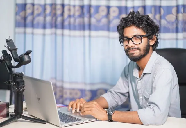 Developer smiling at his laptop