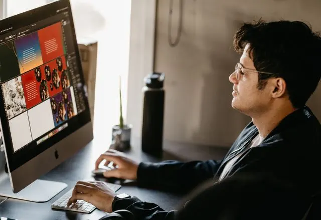 Designer working on a website at a desktop computer